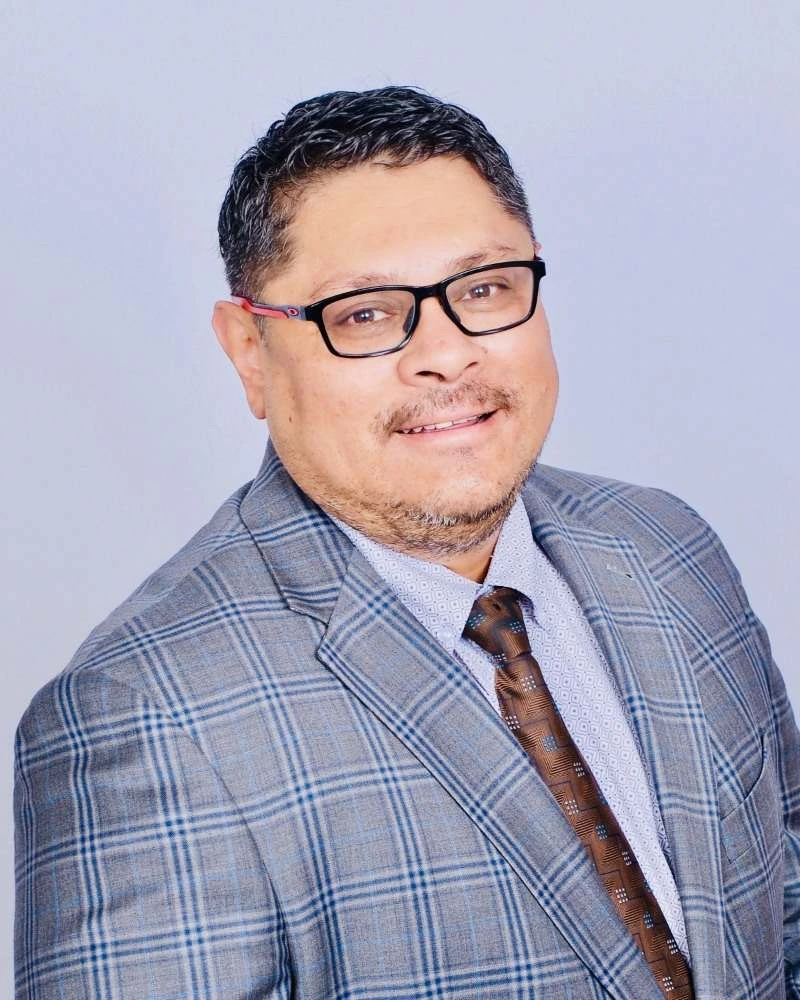 Smiling Real Estate Agent In Plaid Suit