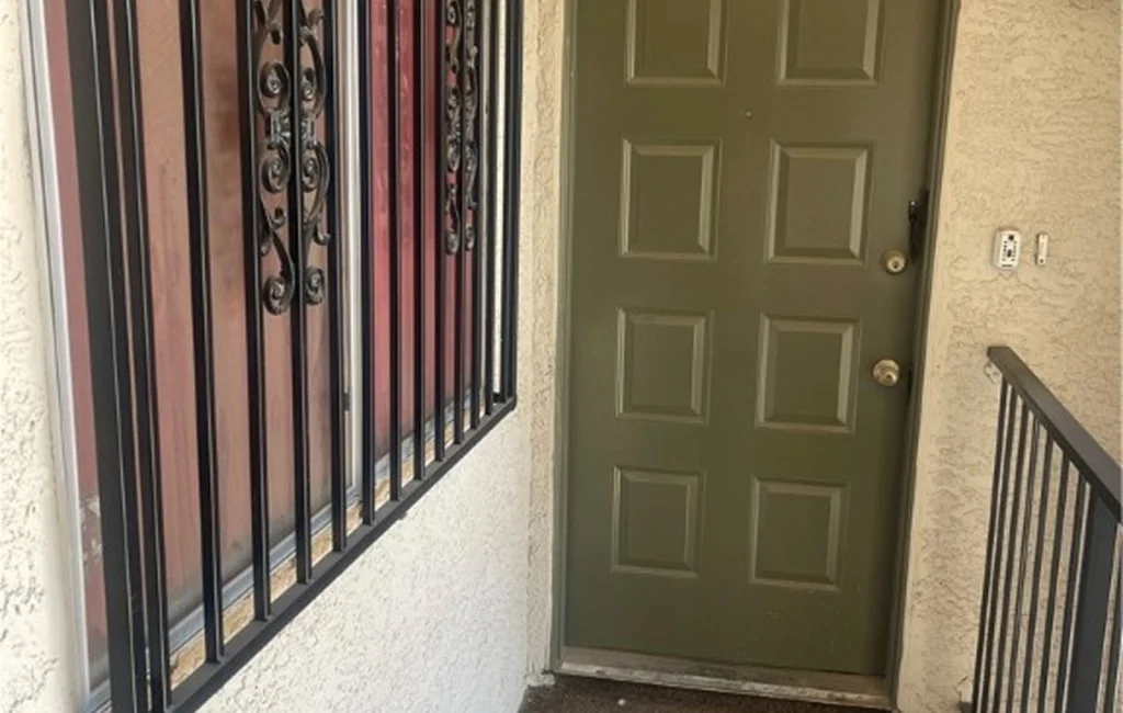 Condo Entrance With Green Door And Security Bars