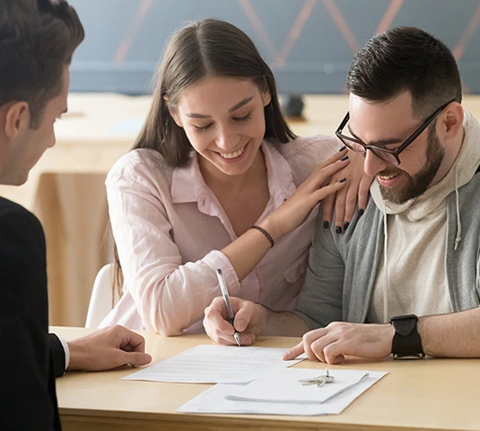 Couple Signing Home Purchase Paperwork