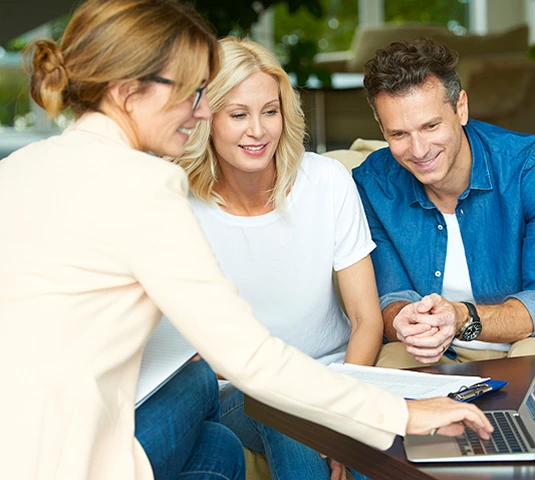 Advisor Presenting Options To Couple On Laptop