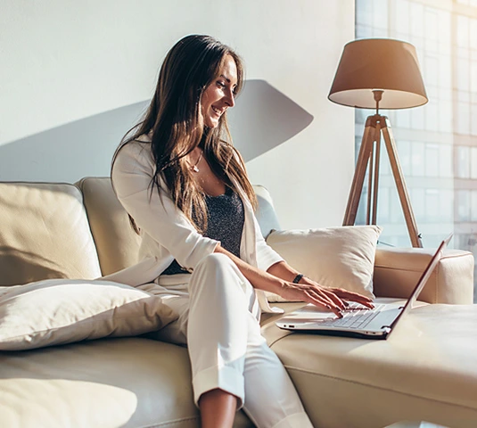 Woman Working On Laptop At Home